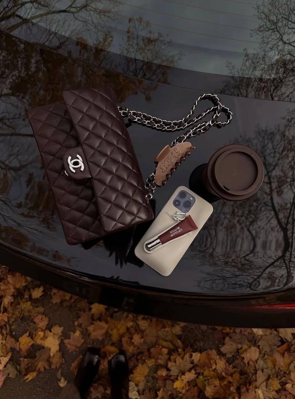 A bag, coffee and everyday essentials on a café table