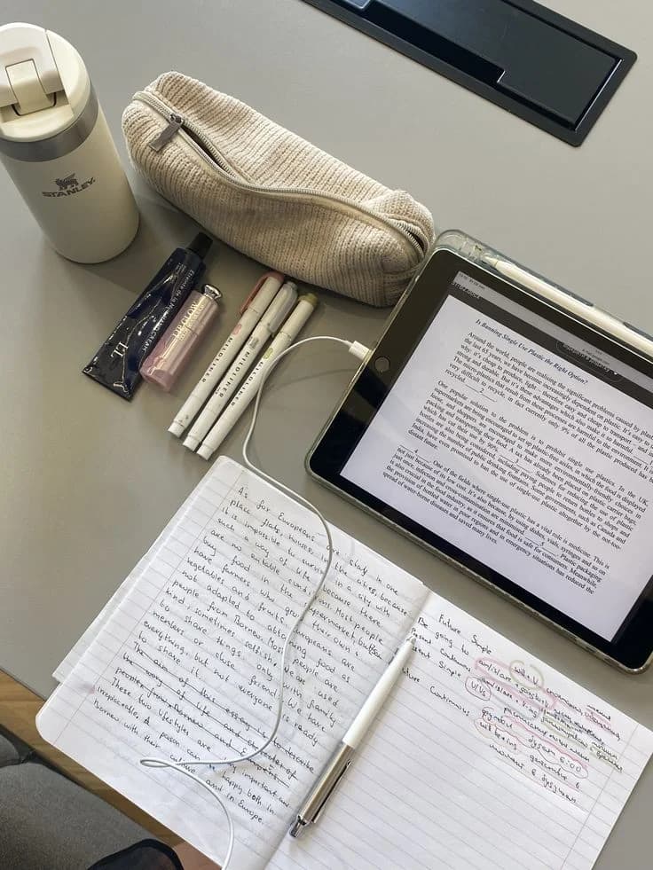 An open notebook and an ebook on a desk